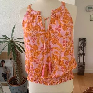 Rose + Olive Sleeveless split neck top with orange and pink floral print on pink